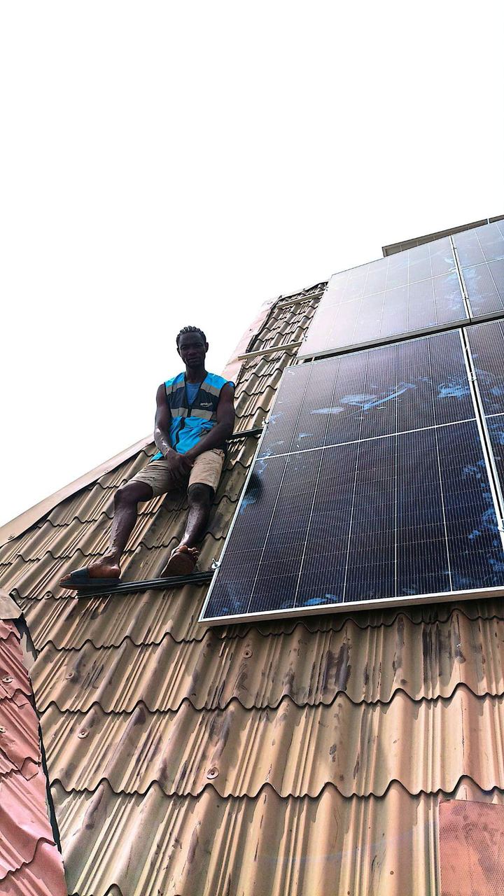 Technician beside newly installed solar panels